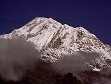 407 Dhaulagiri South Face Early Morning From Lete �Above this stony desert Dhaulagiri rose into swirling clouds, vast and solitary. For twenty thousand feet there was nothing but the glint of riven glaciers, ridges that seemed like streamers in the wind, and somber rock buttresses higher than the Walker. The sight was so overwhelming that we sat down by the side of the trail feeling slightly numbed� (Lionel Terray, Conquistadors of the Useless).